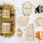 Organic Terra Co. Signature Gift Collection contents — charcoal, unscented and turmeric botanical soaps with 6.4 oz Botanical Butter and lip balm