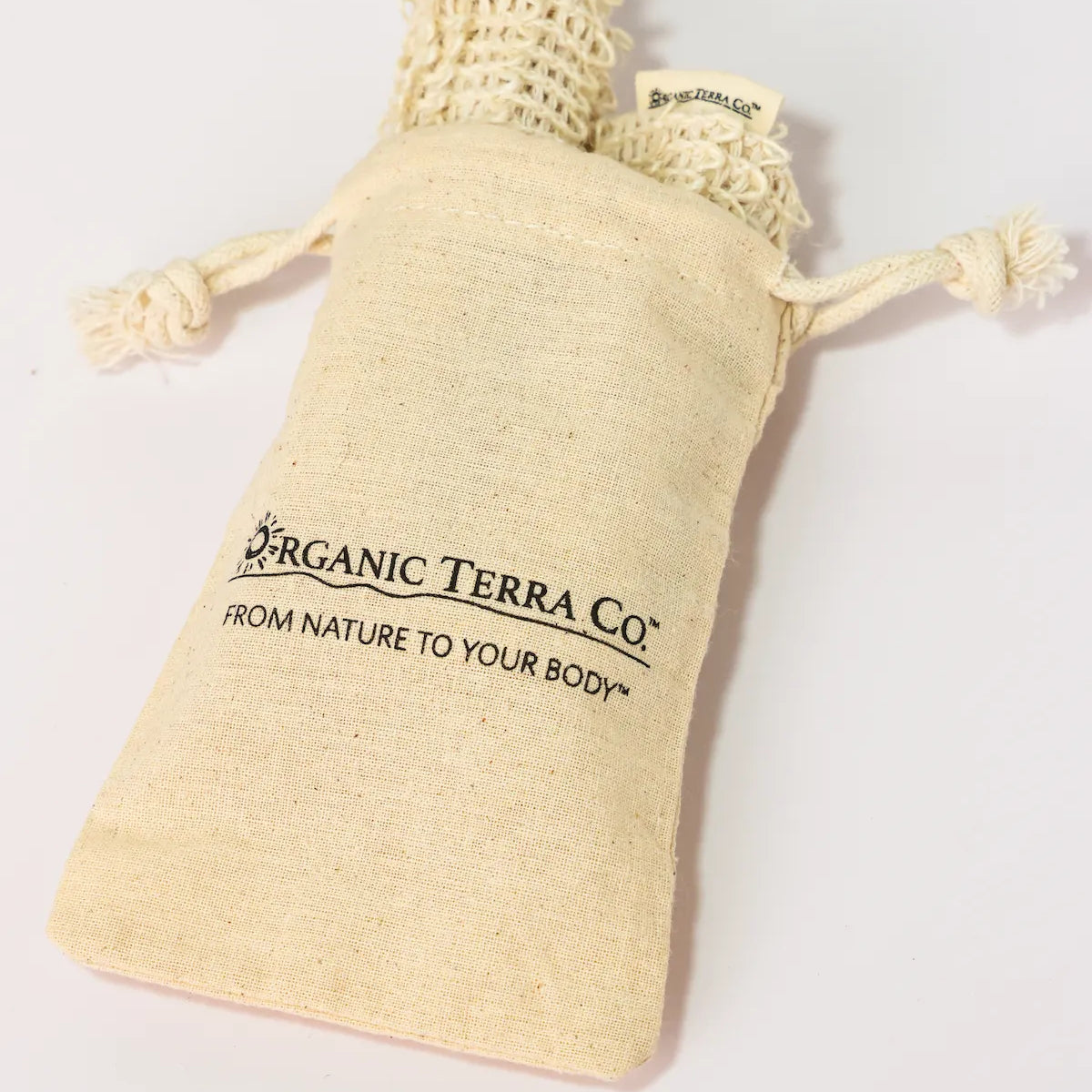 ORGANIC TERRA CO.® branded cotton muslin drawstring pouch containing natural sisal soap bags displaying From Nature To Your Body trademark on white background