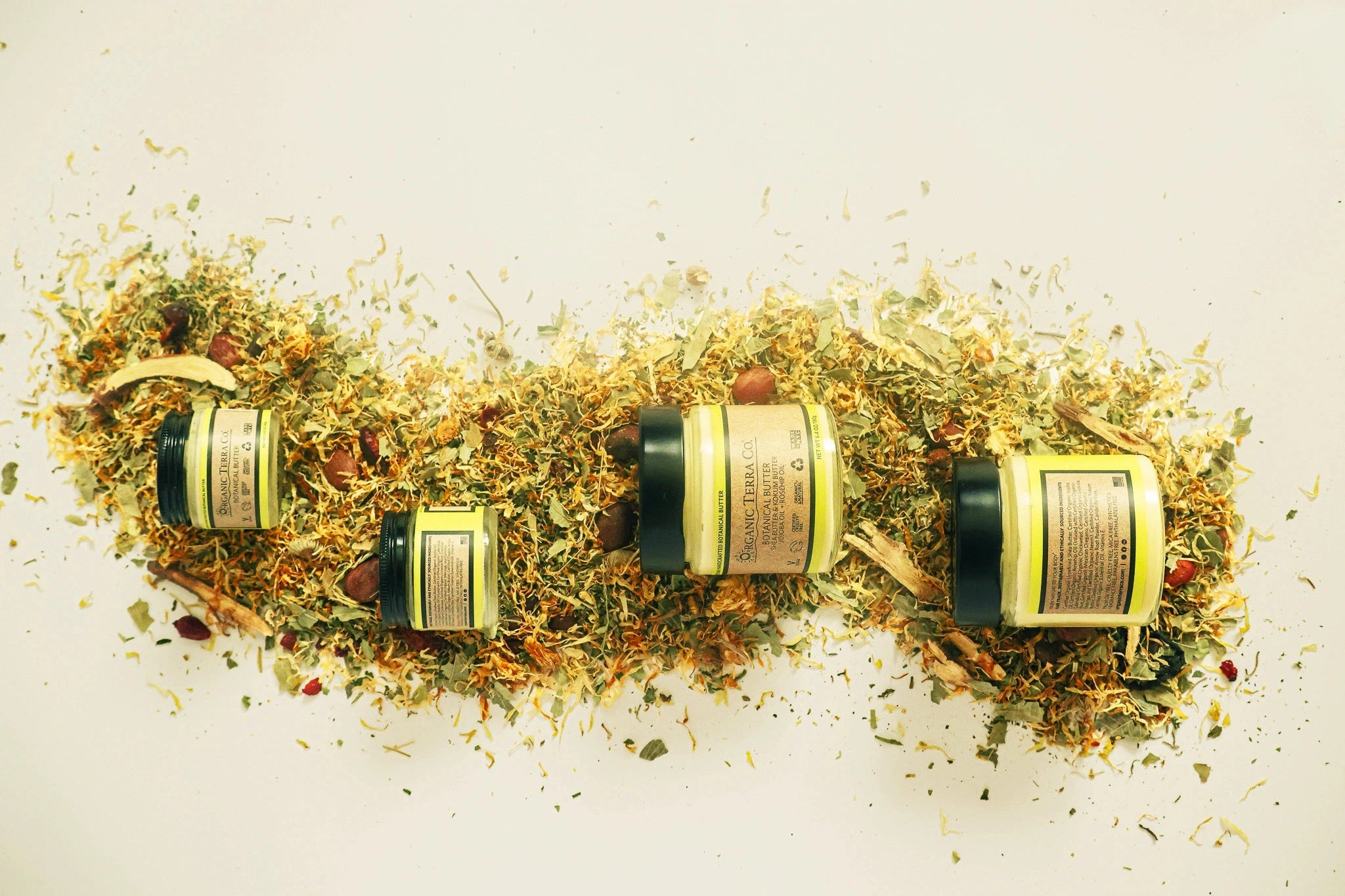 Organic Terra Co. Botanical Butter jars — Shea & Kokum with jojoba and rosehip oils, front and back labels on a bed of dried calendula and botanicals