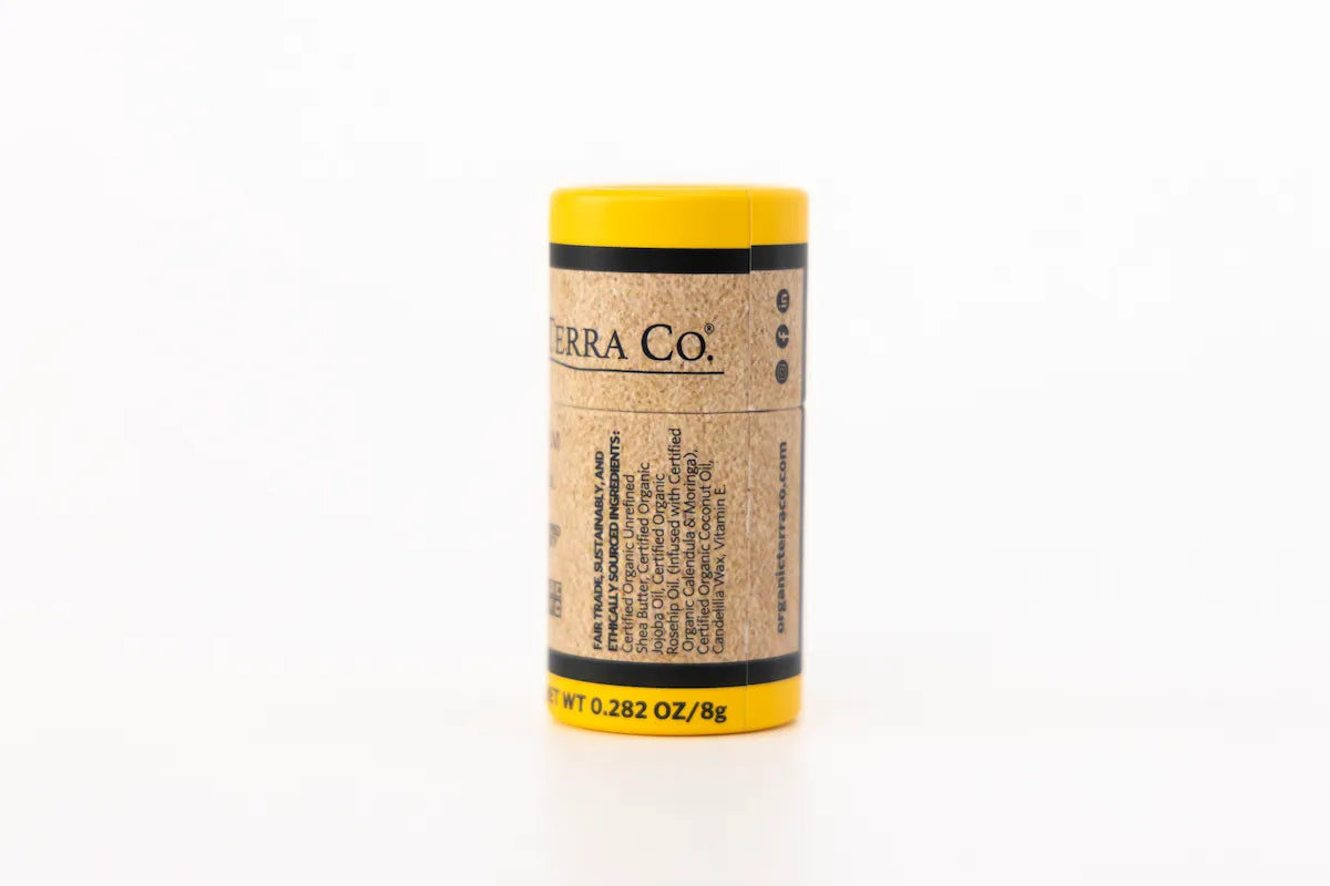 Back label of ORGANIC TERRA CO.® Botanical Lip Balm showing fair trade sustainably and ethically sourced certified organic ingredients list