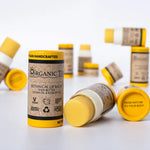  Multiple ORGANIC TERRA CO.® Botanical Lip Balm tubes with shea butter jojoba oil and rosehip oil scattered on white background showing From Nature To Your Body trademark