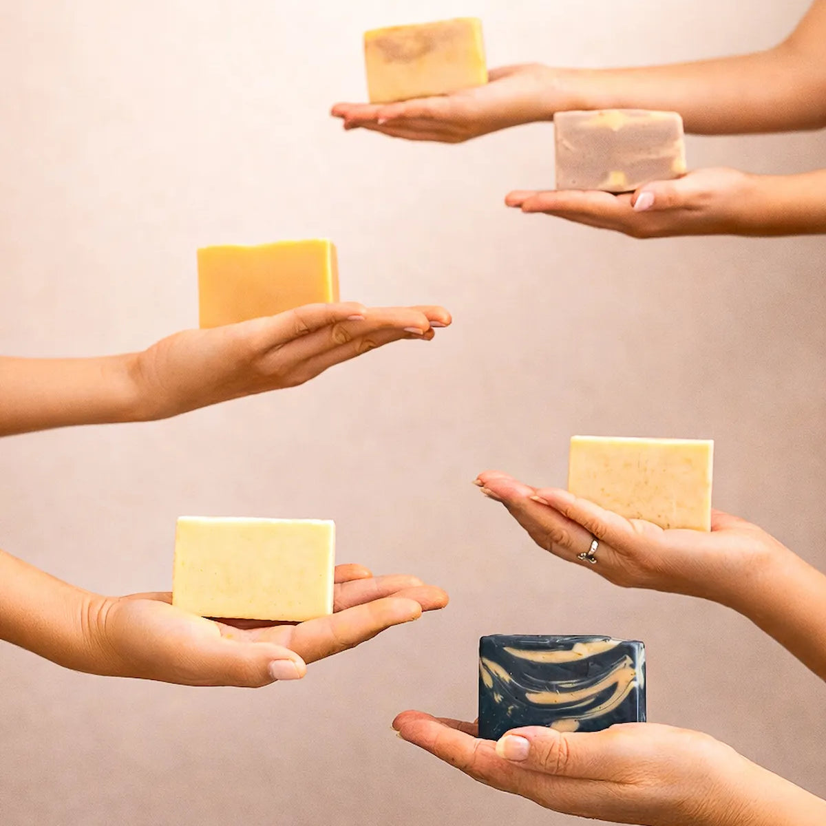 ORGANIC TERRA CO.® botanical soap bars collection held in multiple hands