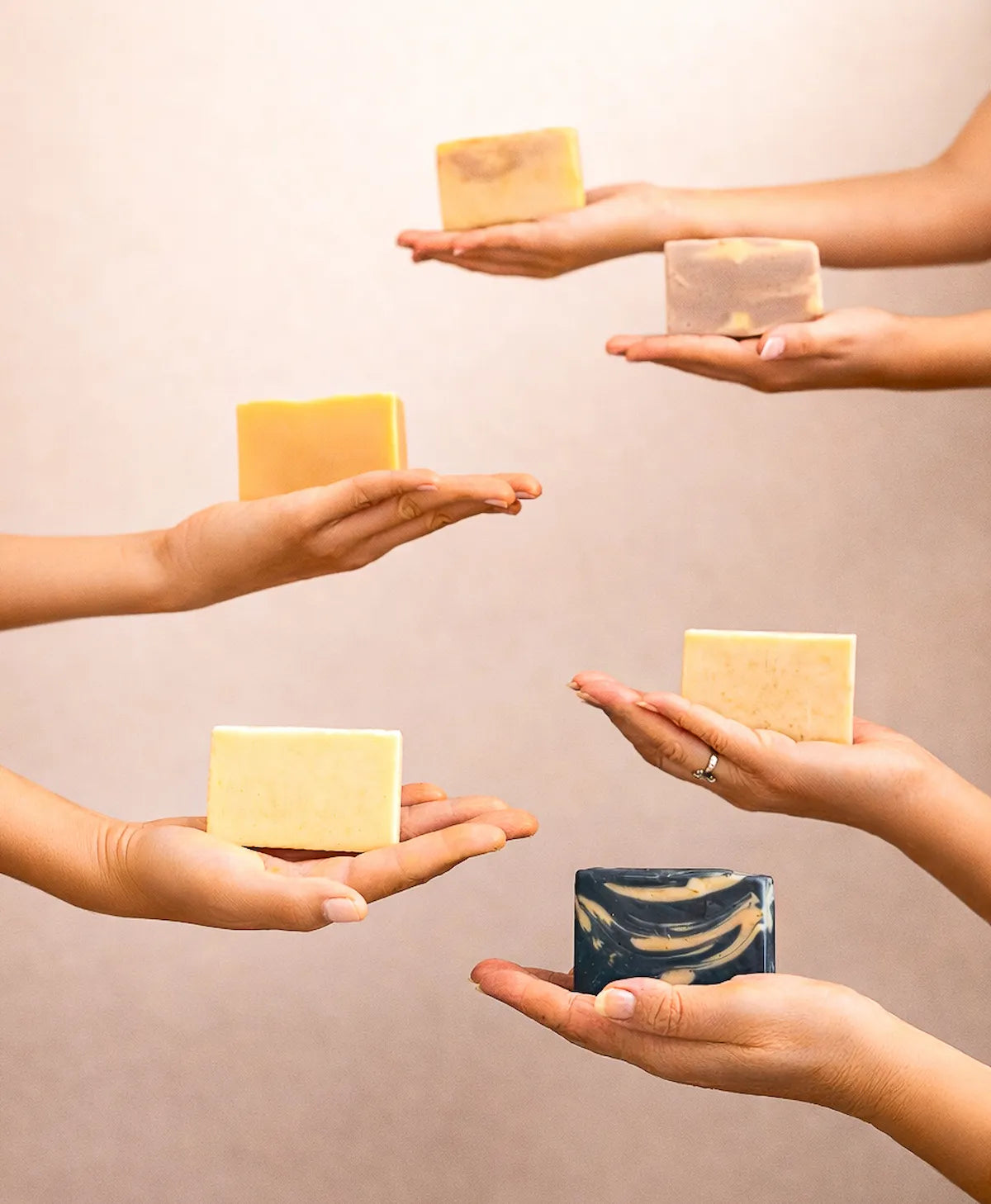 ORGANIC TERRA CO.® botanical soap bars collection held in multiple hands