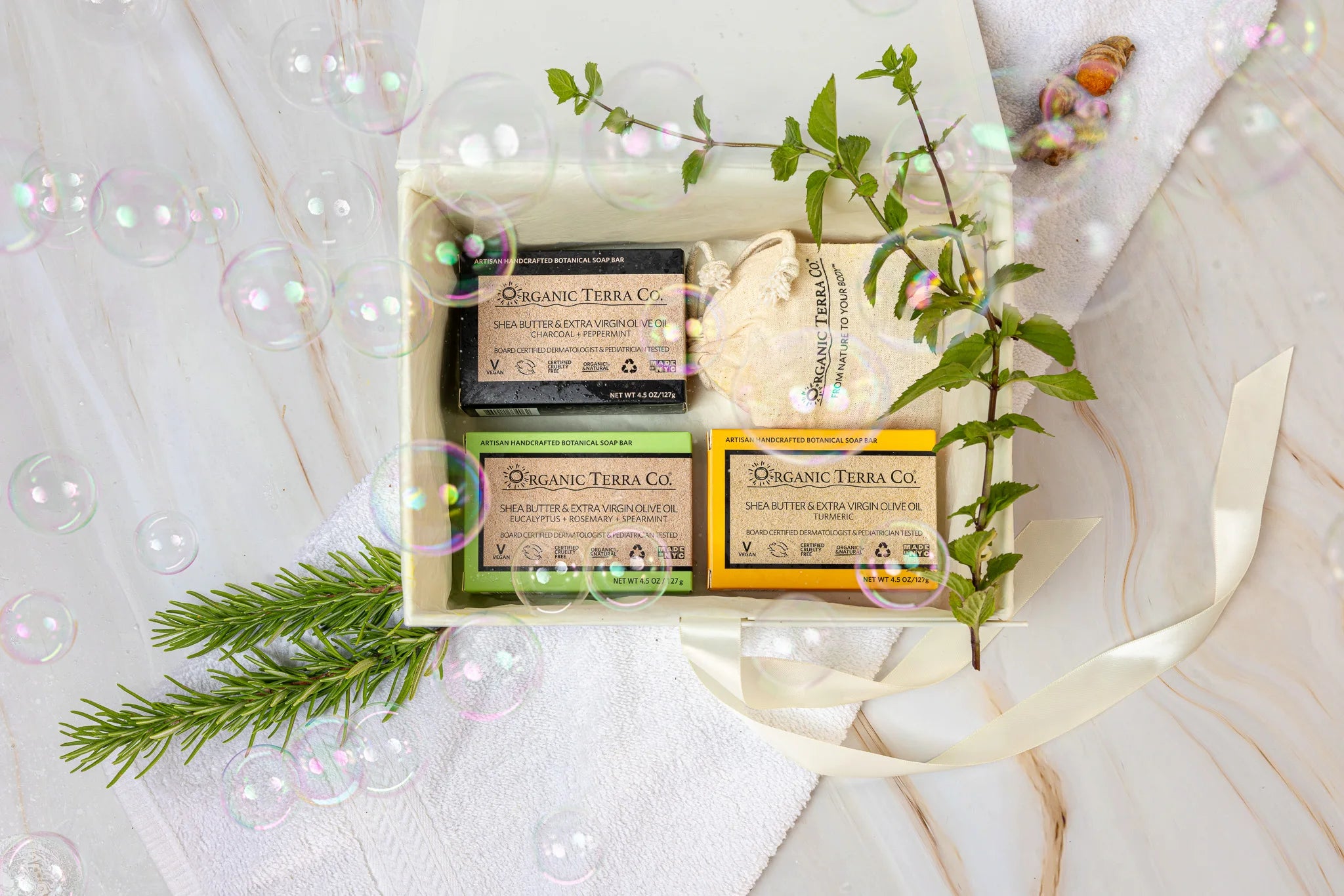 Organic Terra Co. Botanical Cleansing Trio in an open gift box with three handcrafted botanical soap bars