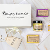 Organic Terra Co. Daily Collection — white gift box with ribbon, two botanical soap bars, 6.4 oz Botanical Butter, lip balm and dried-lavender sachet on a soft towel
