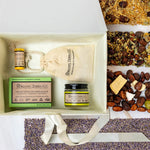 Organic Terra Co. Discovery Collection in an open gift box — botanical soap bar, 2.4 oz Botanical Butter, lip balm and lavender sachet