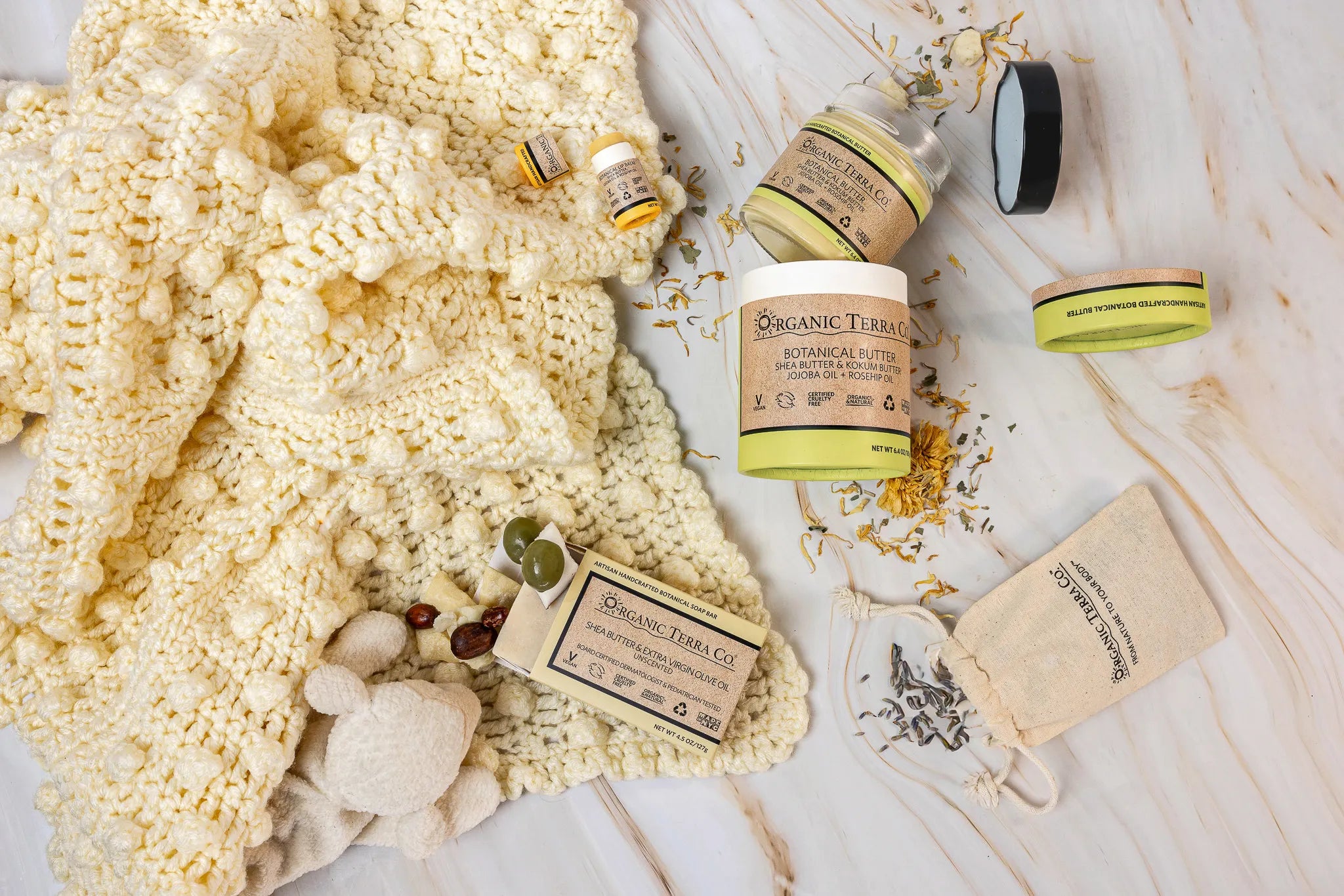Organic Terra Co. Mama & Baby Collection contents — unscented botanical soap bar, 6.4 oz Botanical Butter, lip balm and lavender sachet