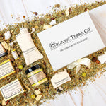 Organic Terra Co. Signature Gift Collection — white gift box with ribbon, three botanical soap bars, Botanical Butter, lip balm and sisal soap saver pouch