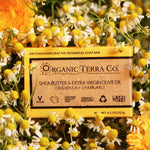 ORGANIC TERRA CO.® Butter Extra Virgin Olive Oil Calendula and Chamomile soap bar box surrounded by fresh chamomile buds and calendula flowers