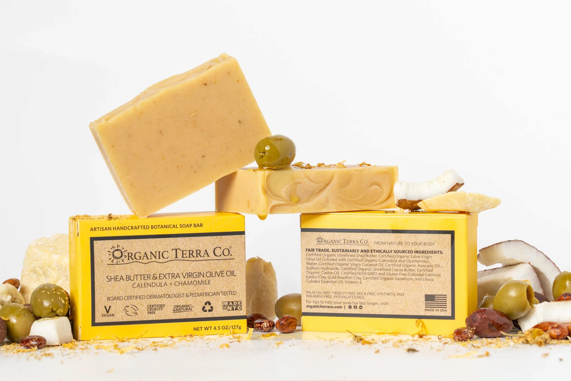 ORGANIC TERRA CO.® Butter Extra Virgin Olive Oil Calendula and Chamomile soap bar front and back packaging showing fair trade ingredients alongside unwrapped bars and dried botanicals