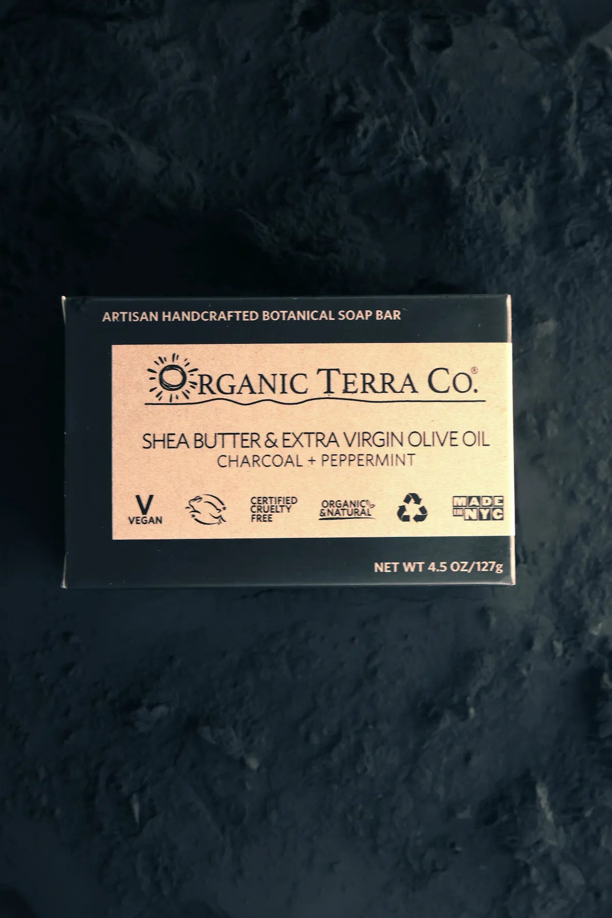 ORGANIC TERRA CO.® Butter Extra Virgin Olive Oil Charcoal and Peppermint soap bar black box on dark textured charcoal stone surface