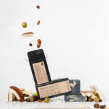ORGANIC TERRA CO.®Shea Butter Extra
Virgin Olive Oil Charcoal and Peppermint soap bar front and back packaging with unwrapped bars and scattered shea nuts olives and cacao beans