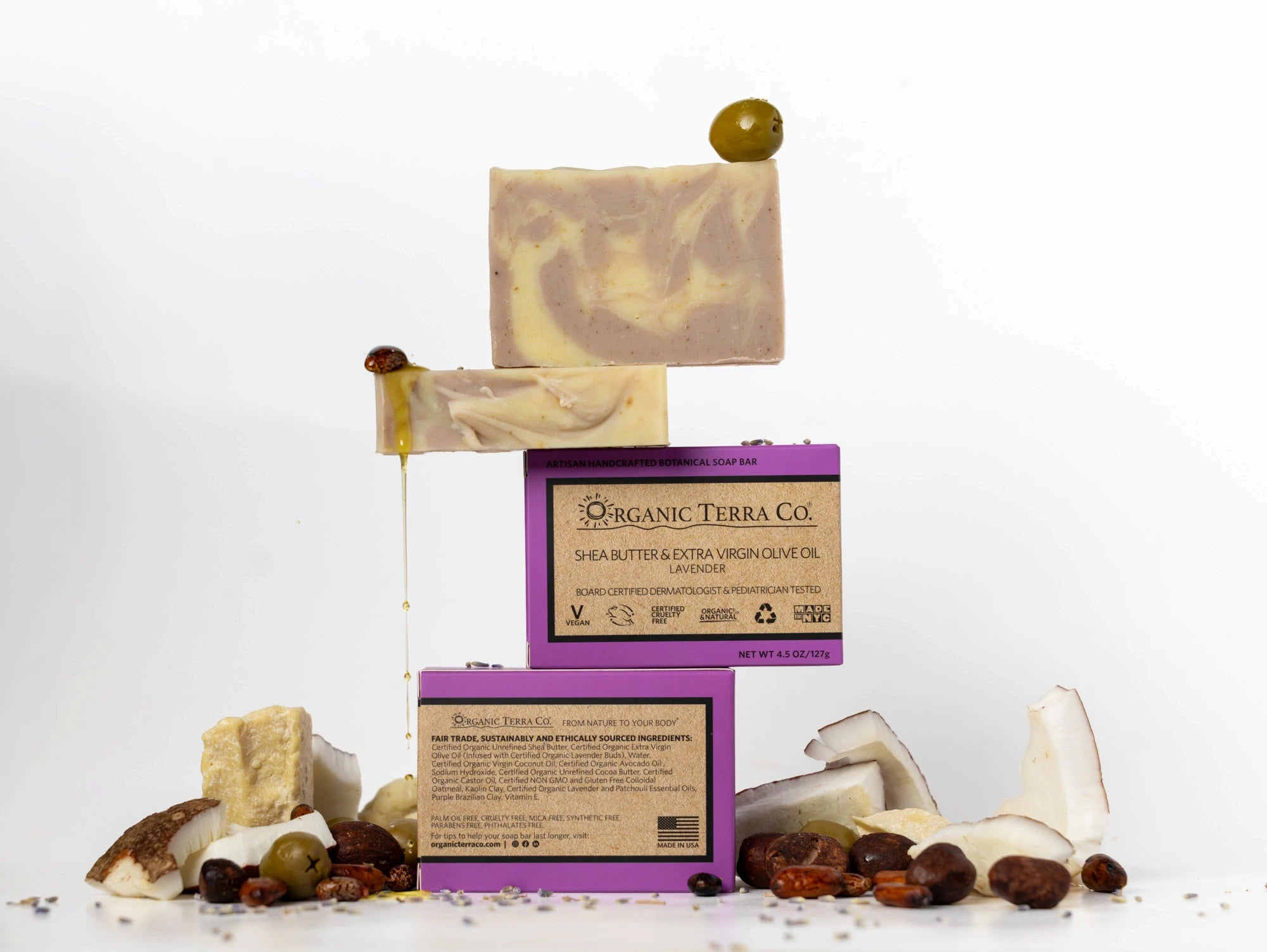 ORGANIC TERRA CO.®Shea Butter Extra
Virgin Olive Oil Lavender soap bar front and back packaging with unwrapped bars and scattered shea nuts olives coconut and lavender buds