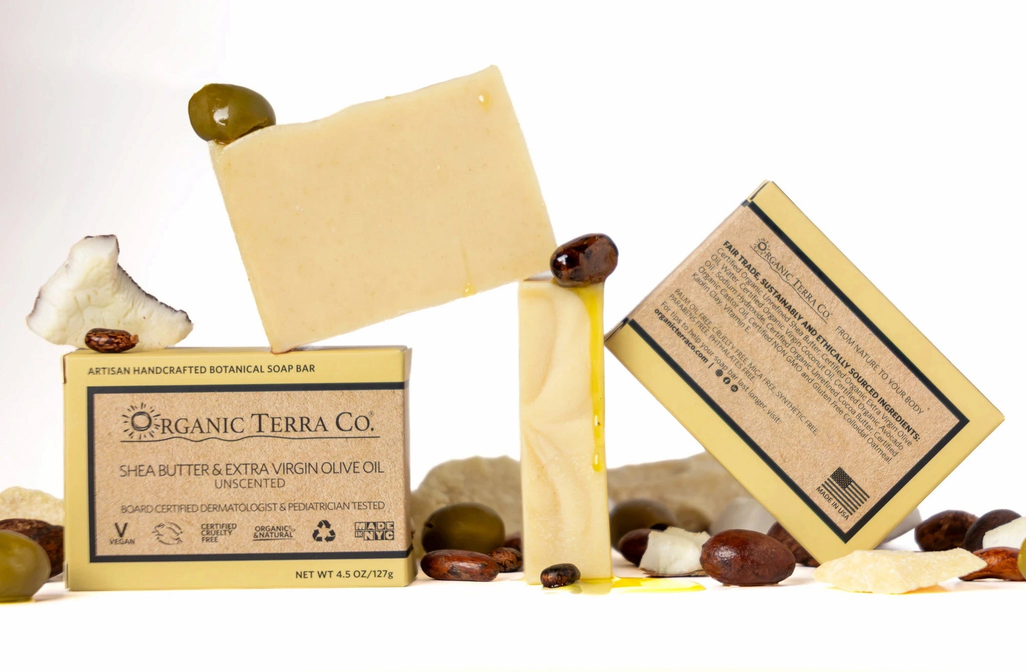 ORGANIC TERRA CO,© Butter and Extra Virgin Olive Oil unscented soap bar showing front and back packaging with fair trade ingredients alongside unwrapped bar and shea nuts